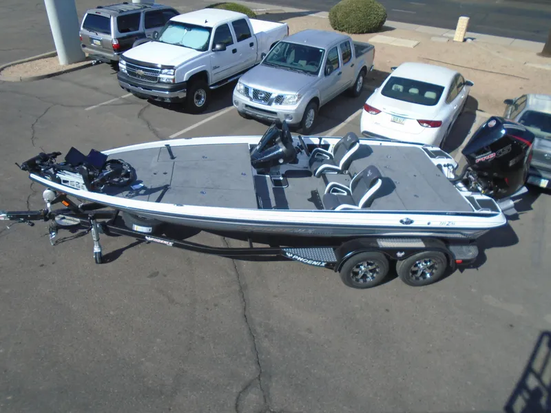Slide: The Image of 2025 Phoenix 721 ZXL boat on trailer in parking lot, surrounded by vehicles. - 3