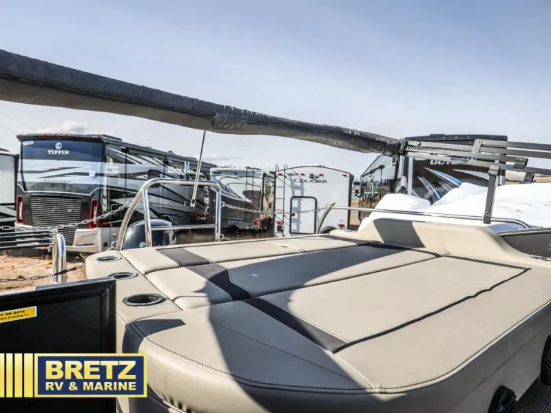 Slide: The Image of 2023 Aria 22UC boat with sun deck, surrounded by RVs at Bretz RV & Marine. - 11