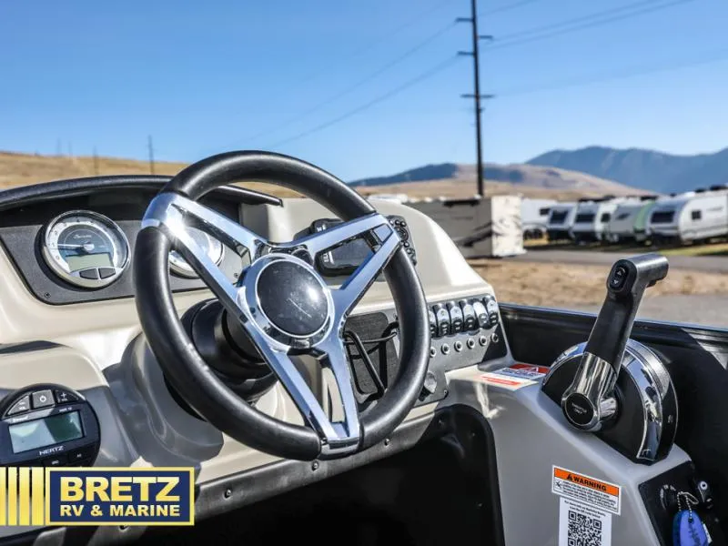 Slide: The Image of Steering wheel and controls of 2023 Aria 22UC boat at Bretz RV & Marine. - 17