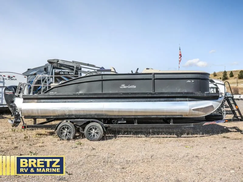 Slide: The Image of 2023 Aria 22UC pontoon boat on trailer at Bretz RV & Marine dealership. - 2
