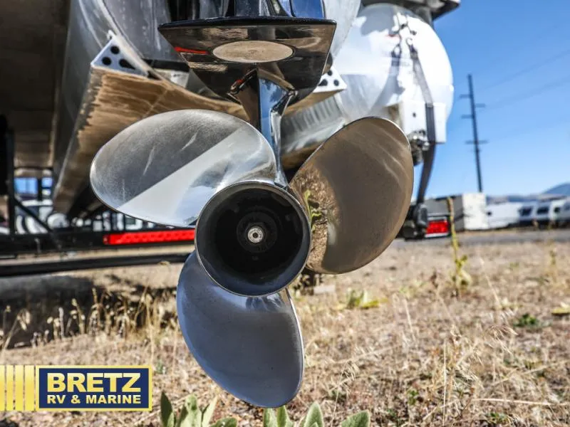 Slide: The Image of Close-up of a 2023 Aria 22UC boat propeller on dry grass. - 6