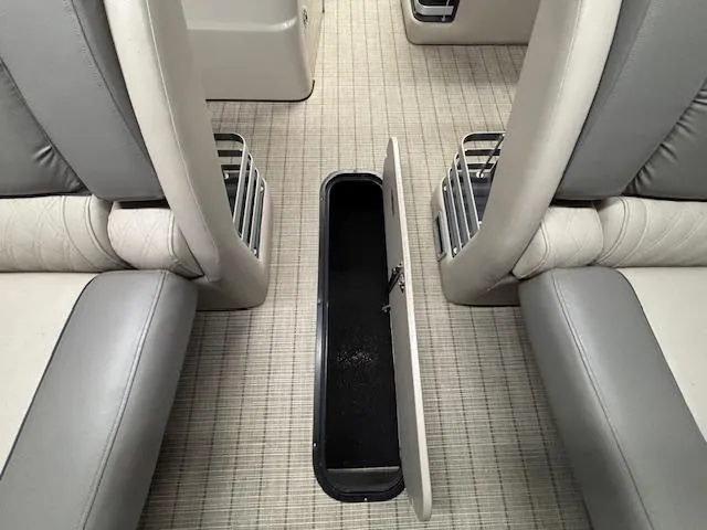 Slide: The Image of 2019 Harris Grand Mariner 250 interior with open storage compartment between seats. - 10