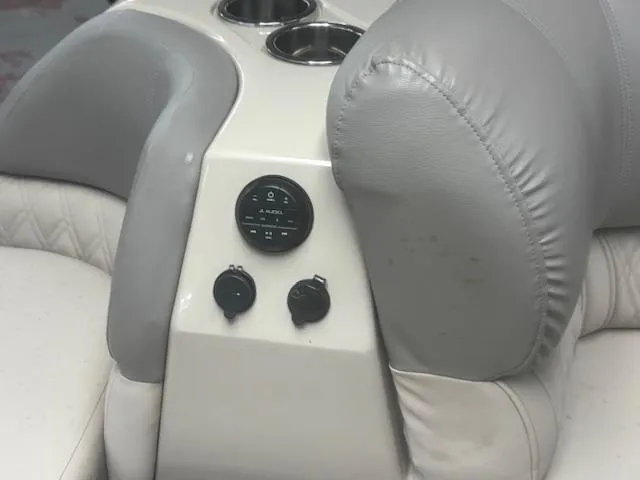 Slide: The Image of Interior of 2019 Harris Grand Mariner 250 boat with cup holders and control panel. - 19