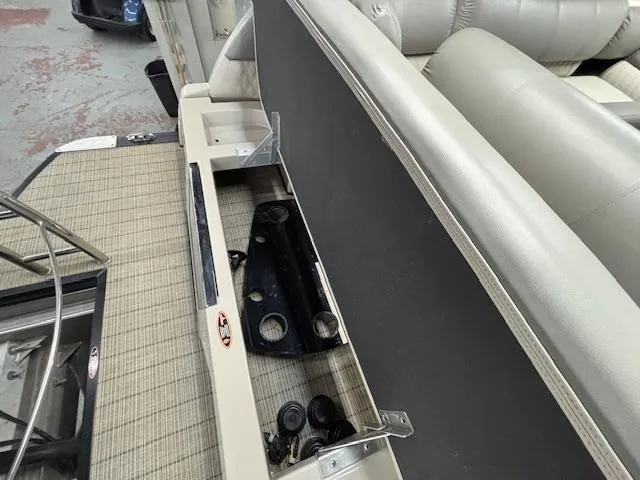 Slide: The Image of 2019 Harris Grand Mariner 250 boat interior with open storage compartment and seating. - 21