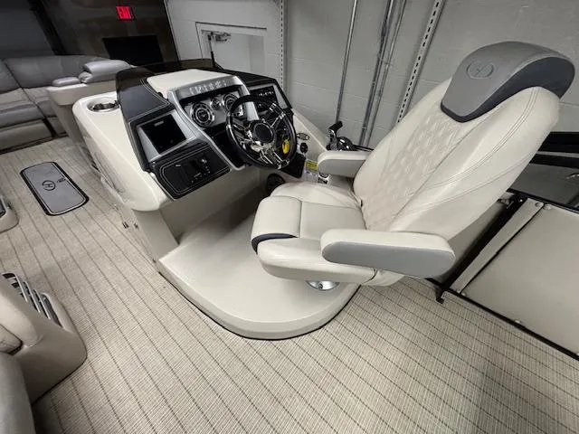 Slide: The Image of 2019 Harris Grand Mariner 250 boat interior with captain's chair and control panel. - 28