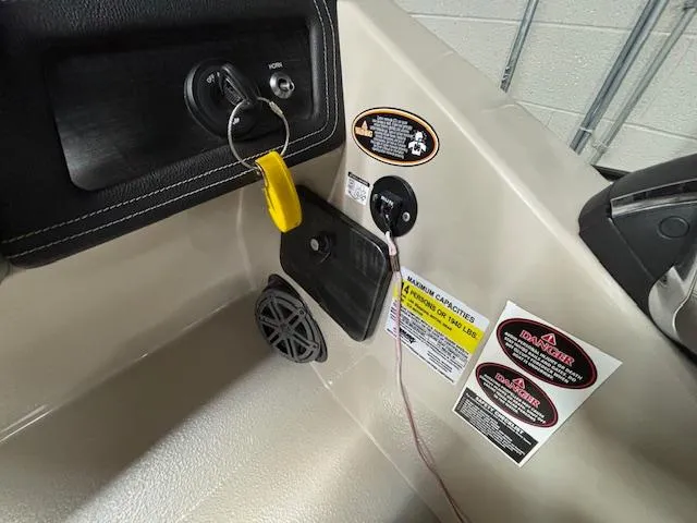 Slide: The Image of Control panel of 2019 Harris Grand Mariner 250 boat with safety labels and ignition key. - 29