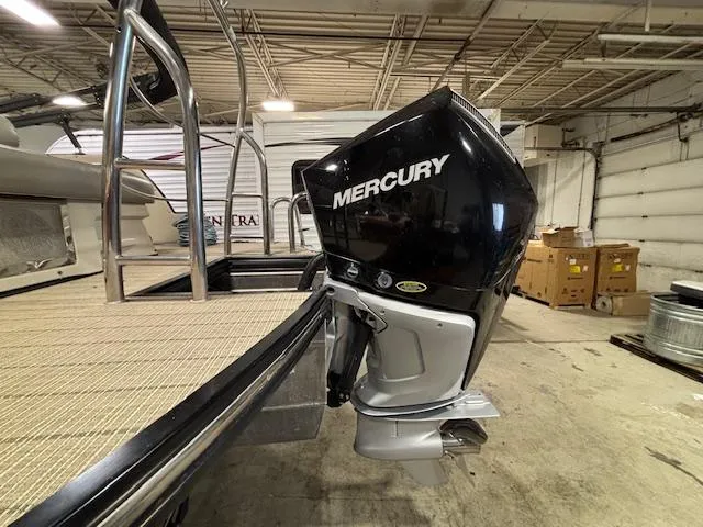 Slide: The Image of 2019 Harris Grand Mariner 250 with Mercury outboard motor in a garage setting. - 3