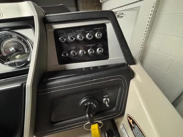Slide: The Image of Control panel of a 2019 Harris Grand Mariner 250 boat with switches and ignition key. - 31