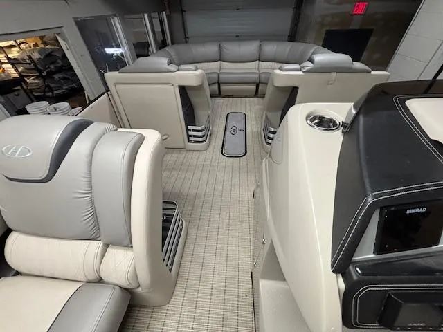 Slide: The Image of 2019 Harris Grand Mariner 250 interior with luxurious seating and modern dashboard. - 34