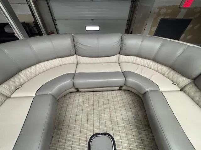 Slide: The Image of 2019 Harris Grand Mariner 250 interior with gray and white seating in a garage. - 38
