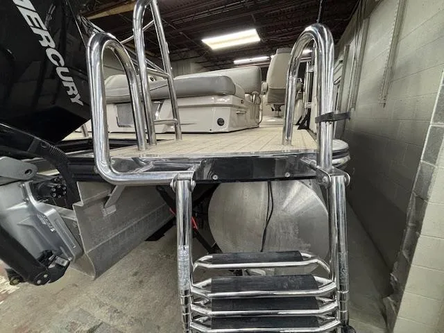 Slide: The Image of 2019 Harris Grand Mariner 250 boat with ladder and Mercury engine in a garage. - 43