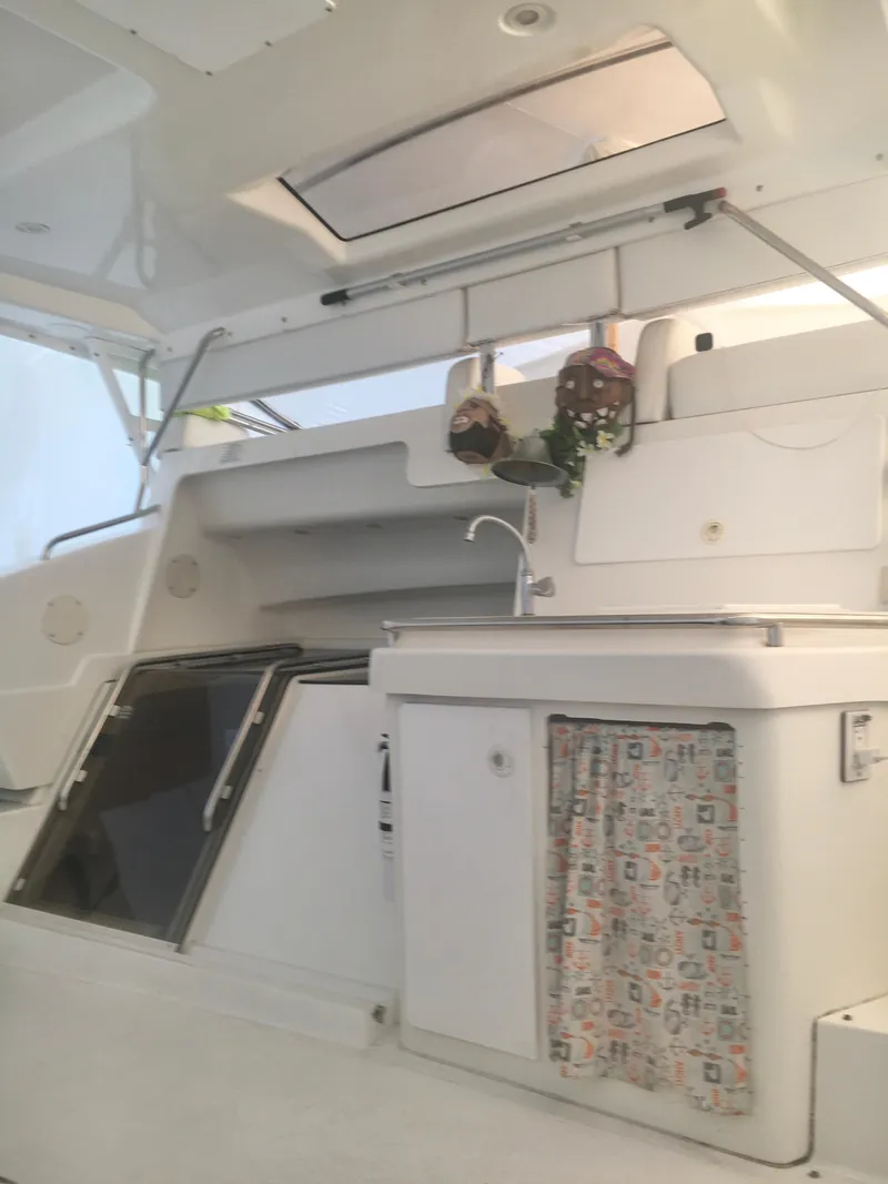 Slide: The Image of 1996 Silverton 372 Motor Yacht interior with kitchenette, sink, and storage. - 11