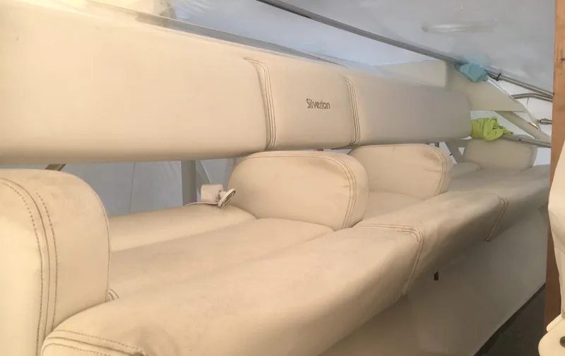Slide: The Image of 1996 Silverton 372 Motor Yacht interior with beige seating and cushions. - 16