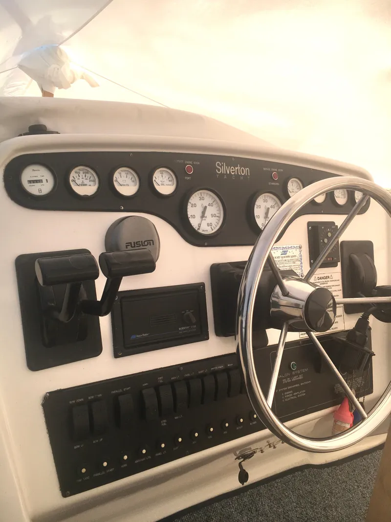 Slide: The Image of 1996 Silverton 372 Motor Yacht helm with gauges and steering wheel. - 21