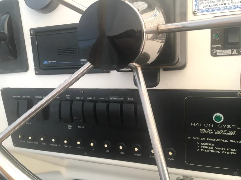 Slide: The Image of 1996 Silverton 372 Motor Yacht helm with steering wheel and control panel. - 23
