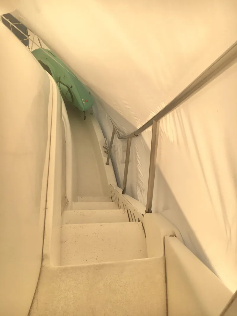 Slide: The Image of Staircase inside 1996 Silverton 372 Motor Yacht, covered with protective tarp. - 24
