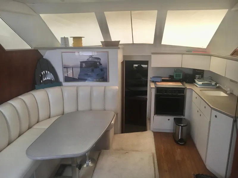 Slide: The Image of Interior of 1996 Silverton 372 Motor Yacht with dining area and kitchen. - 29