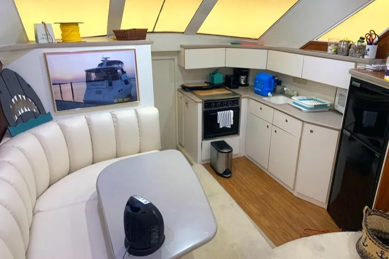 Slide: The Image of Interior of 1996 Silverton 372 Motor Yacht with kitchen and seating area. - 30