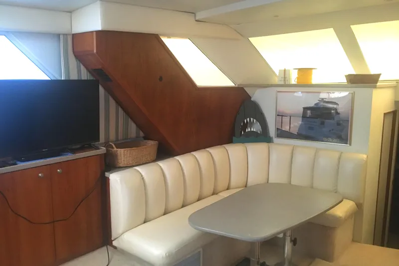 Slide: The Image of Interior of 1996 Silverton 372 Motor Yacht with cozy seating and modern decor. - 31