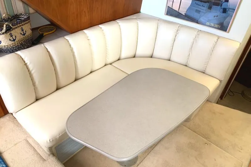 Slide: The Image of 1996 Silverton 372 Motor Yacht interior with cream leather seating and table. - 32