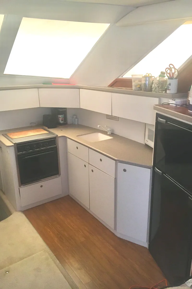 Slide: The Image of Interior of 1996 Silverton 372 Motor Yacht kitchen with modern appliances and wooden flooring. - 35