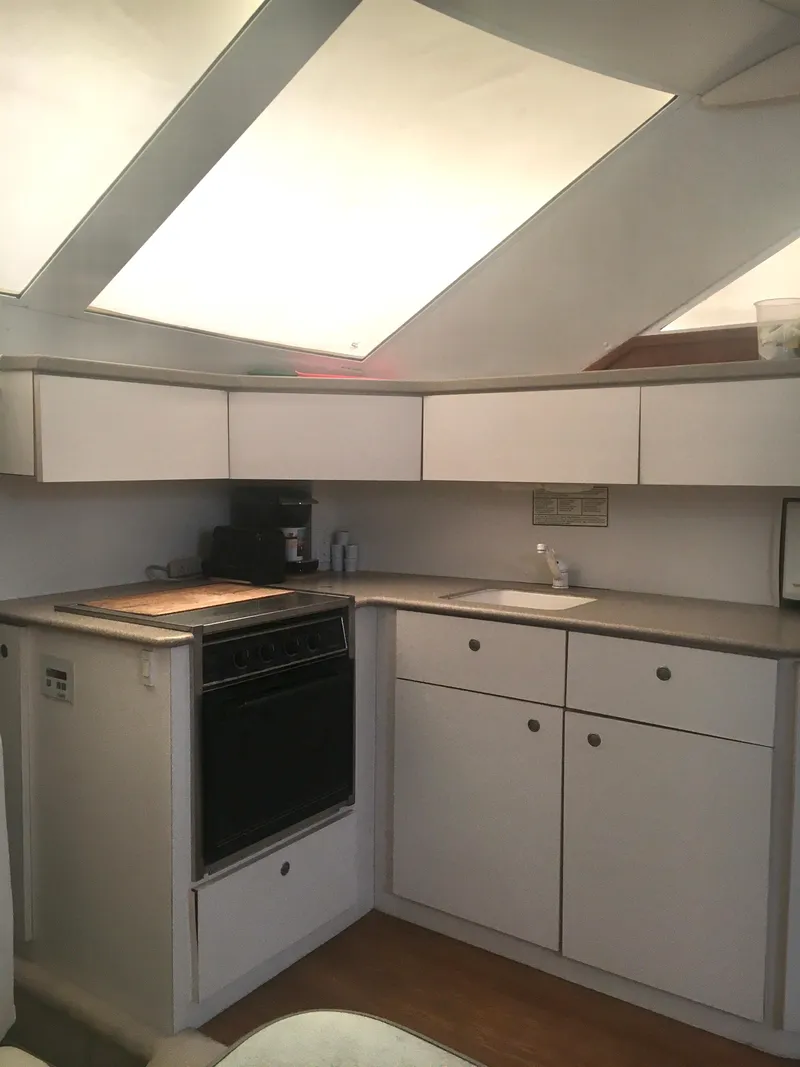 Slide: The Image of Interior of 1996 Silverton 372 Motor Yacht kitchen with stove and sink. - 37
