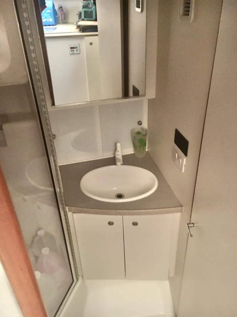Slide: The Image of 1996 Silverton 372 Motor Yacht bathroom with sink, mirror, and storage cabinet. - 39