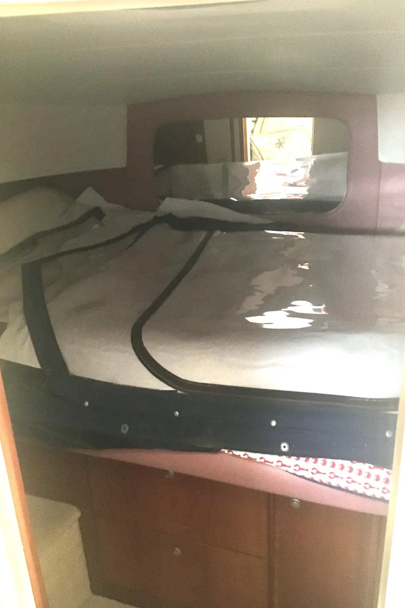 Slide: The Image of 1996 Silverton 372 Motor Yacht cabin interior with bed and storage. - 42