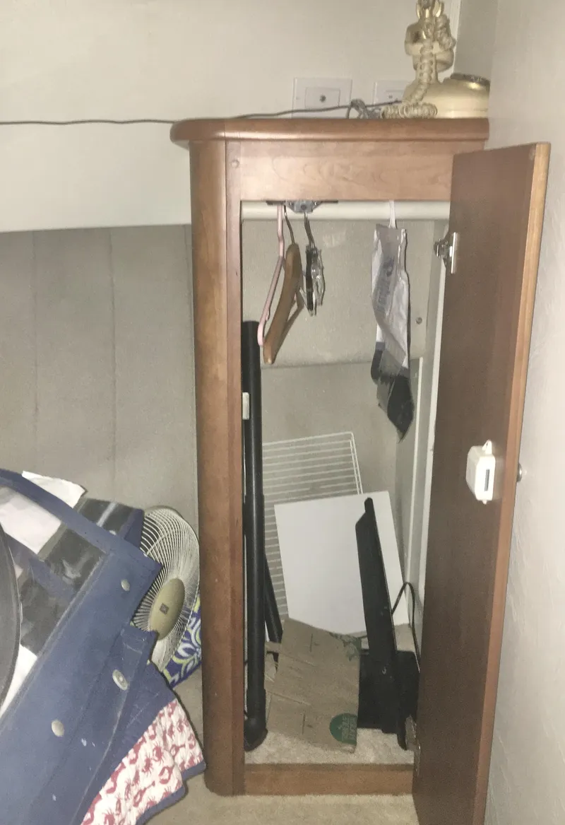 Slide: The Image of 1996 Silverton 372 Motor Yacht interior closet with miscellaneous items. - 45
