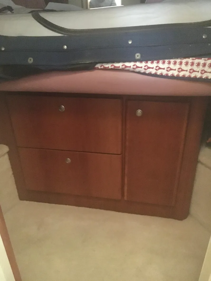 Slide: The Image of 1996 Silverton 372 Motor Yacht interior with wooden cabinetry and storage. - 46