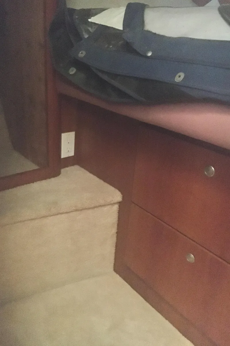 Slide: The Image of Interior of 1996 Silverton 372 Motor Yacht with wooden cabinetry and carpeted steps. - 47