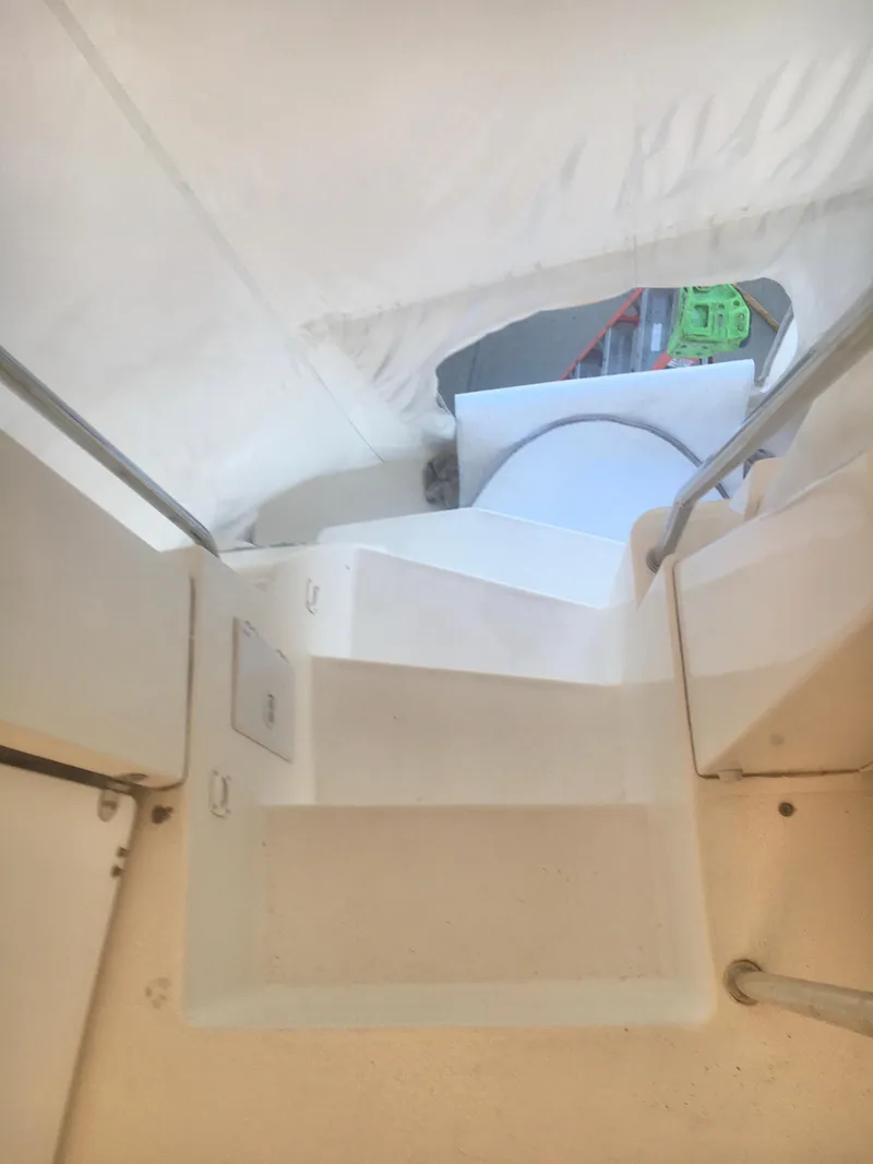 Slide: The Image of Interior stairs of 1996 Silverton 372 Motor Yacht, featuring white steps and railing. - 9