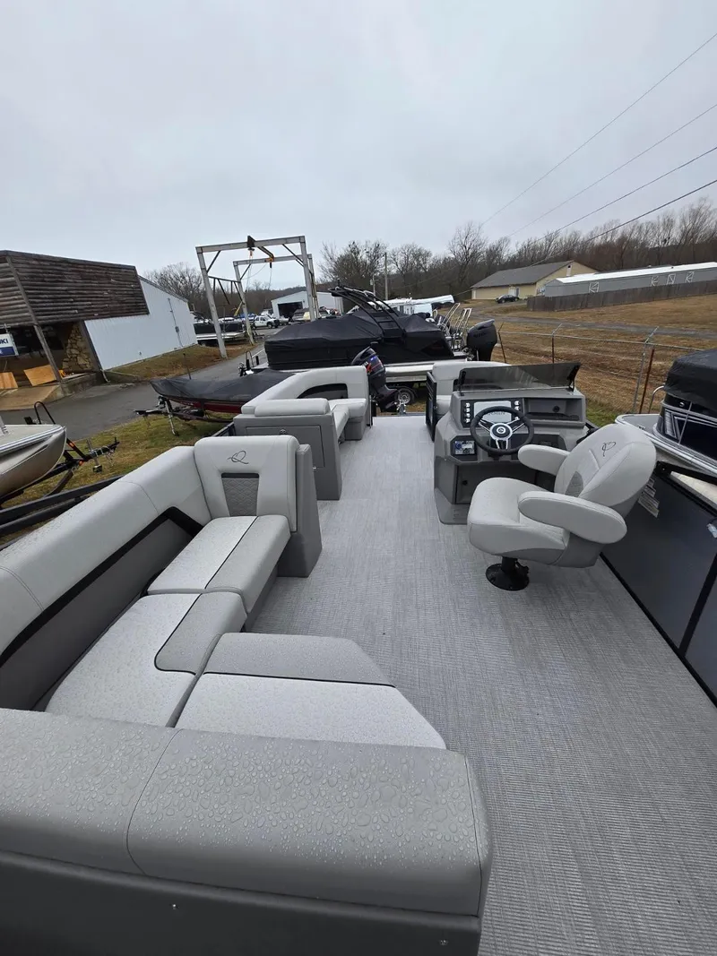 Slide: The Image of 2025 Qwest E-Class 22 XRE Cruise pontoon boat with spacious seating and modern helm. - 2