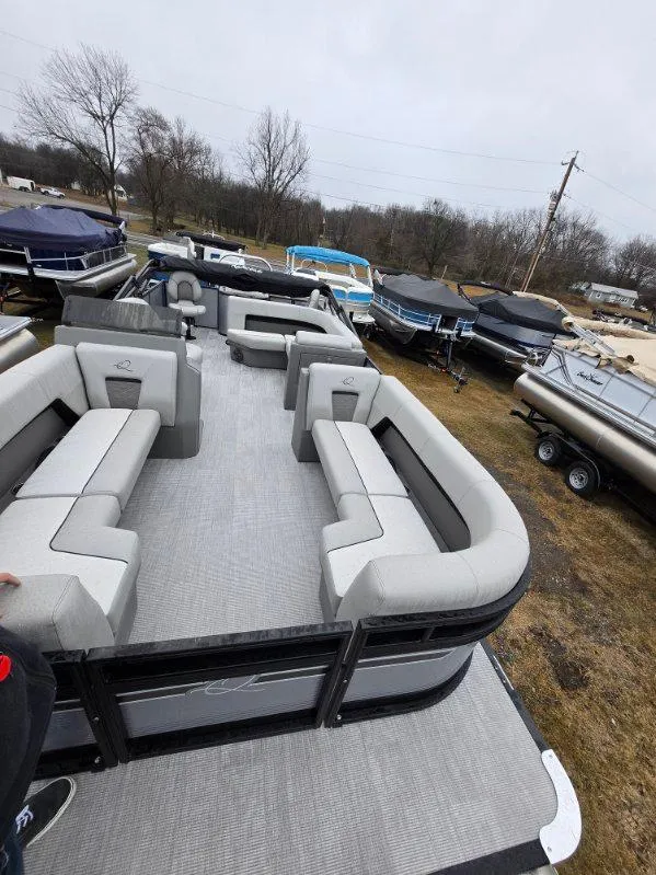 Slide: The Image of 2025 Qwest E-Class 22 XRE Cruise pontoon boat with spacious seating, displayed outdoors. - 5