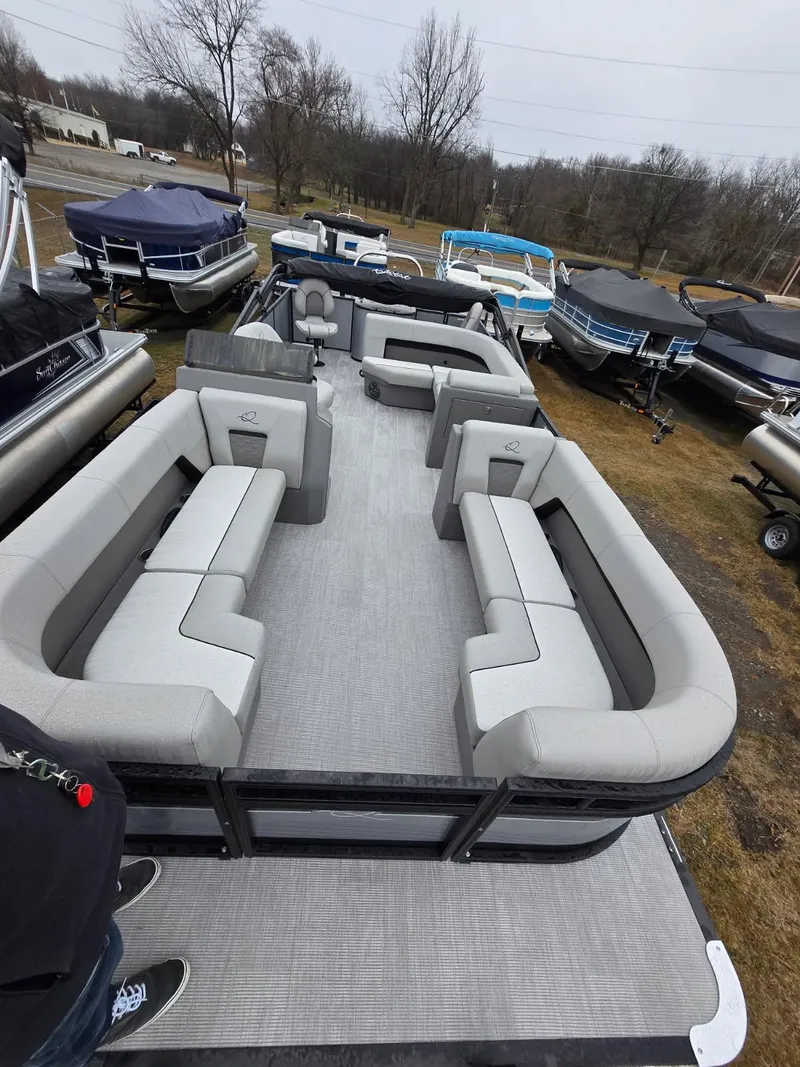 Slide: The Image of 2025 Qwest E-Class 22 XRE Cruise pontoon boat with spacious seating, displayed outdoors. - 9