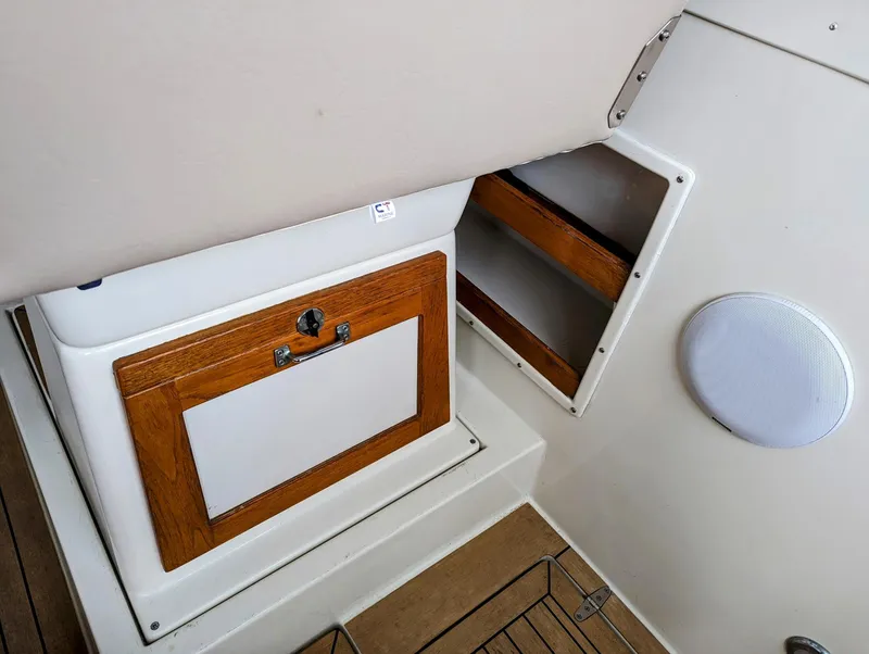 Slide: The Image of Interior detail of 2000 Hunt Yachts 28 Hardtop Express, featuring wooden cabinetry and speaker. - 16