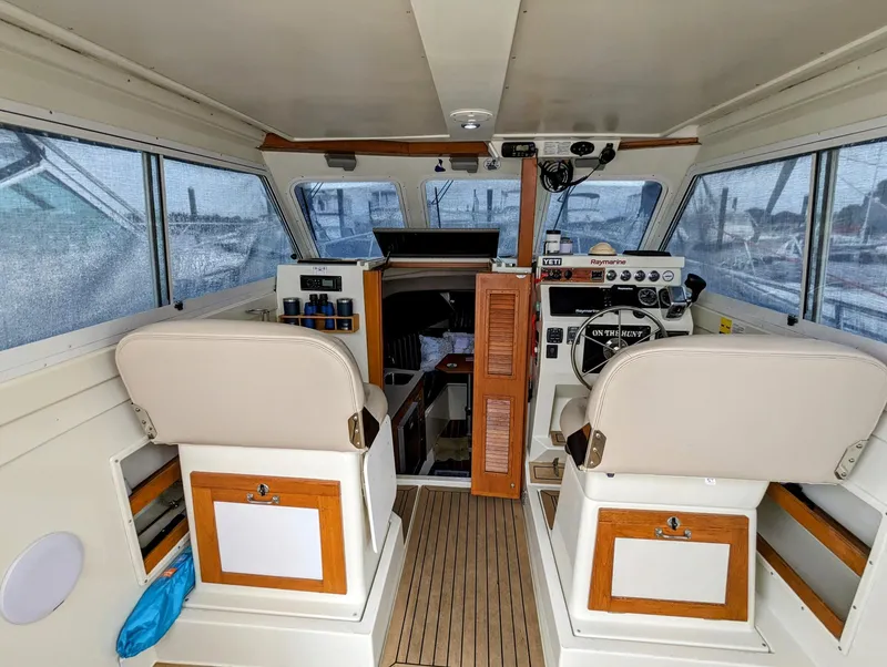 Slide: The Image of Interior of 2000 Hunt Yachts 28 Hardtop Express, featuring helm and seating area. - 17
