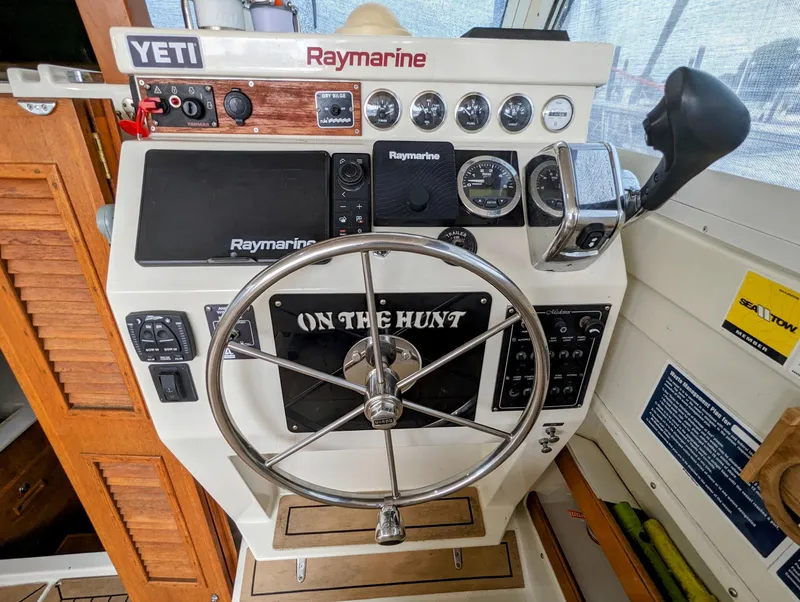 Slide: The Image of 2000 Hunt Yachts 28 Hardtop Express helm with Raymarine electronics and steering wheel. - 21