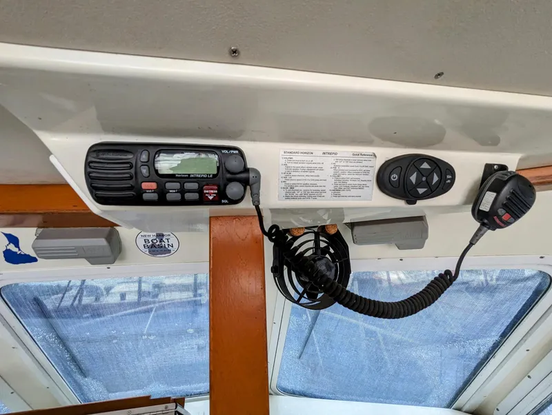 Slide: The Image of Control panel of 2000 Hunt Yachts 28 Hardtop Express with radio and microphone. - 22