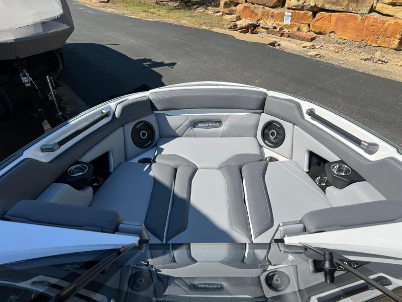 Slide: The Image of 2024 Supra SL boat interior with gray seating and built-in speakers. - 17