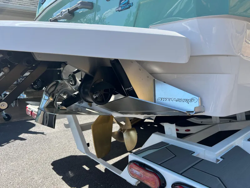 Slide: The Image of 2024 Supra SL boat rear view, showcasing propeller and exhaust system. - 22