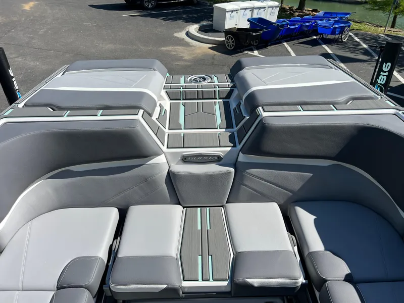 Slide: The Image of 2024 Supra SL boat interior with sleek gray seating and modern design. - 25