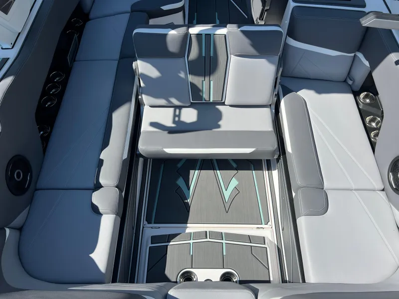 Slide: The Image of 2024 Supra SL boat interior with gray seating and stylish flooring design. - 27