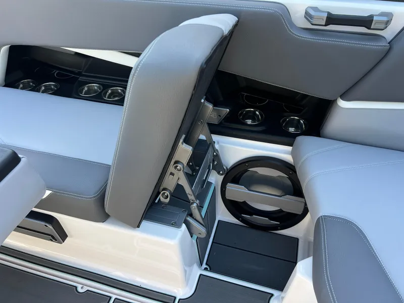 Slide: The Image of 2024 Supra SL boat interior with gray seating and cup holders. - 29