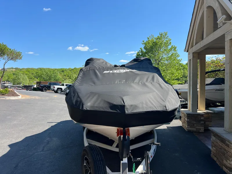 Slide: The Image of 2024 Supra SL boat covered, parked outdoors on a sunny day. - 8