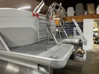 Slide: The Image of 2025 Sweetwater 2286SB pontoon boat in a workshop, featuring a sleek aluminum deck. - 19