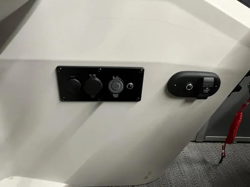 Slide: The Image of Control panel of 2025 Sweetwater 2286SB boat with power outlets and switches. - 21