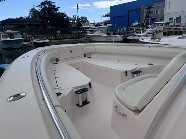 Slide: The Image of 2008 Grady-White 336 Canyon boat interior, featuring spacious seating and storage, docked at a marina. - 23