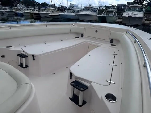 Slide: The Image of 2008 Grady-White 336 Canyon boat interior with seating and storage, docked at marina. - 24