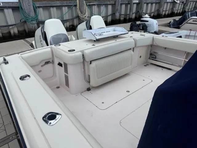 Slide: The Image of 2008 Grady-White 336 Canyon boat deck with seating and storage at a marina. - 26